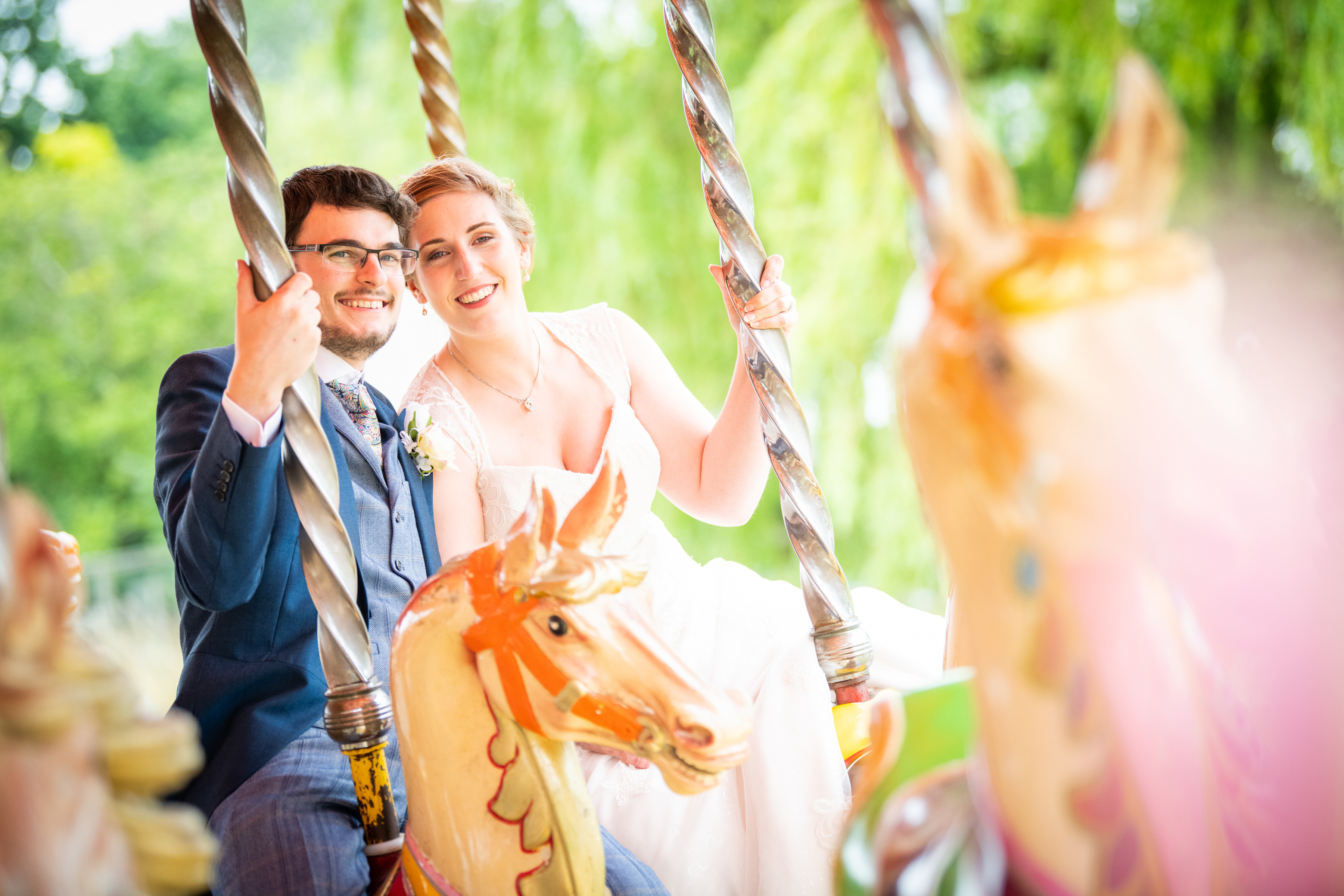 bride and groom on carousel